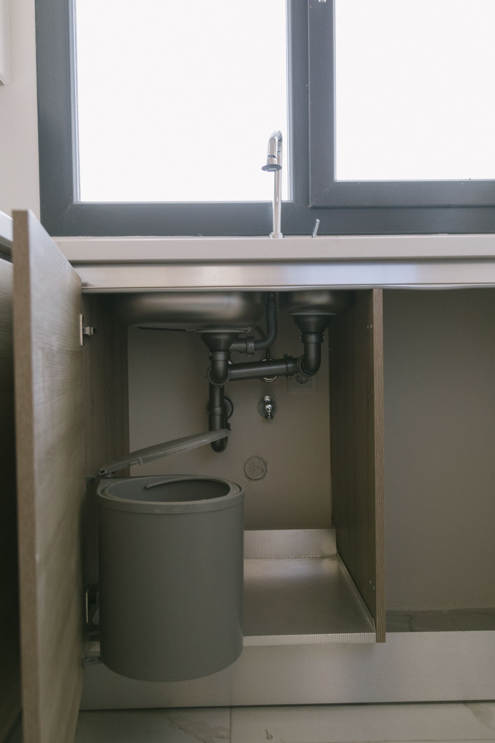 Plumbing drain assembly beneath a sink